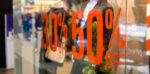 a shop window displaying discount signage