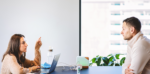two people talking in an office across a table