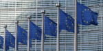 European Union flags waving in front of the European Commission building in Brussels